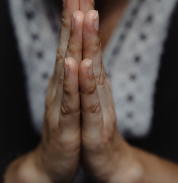 Close up of hands in a meditative position.
